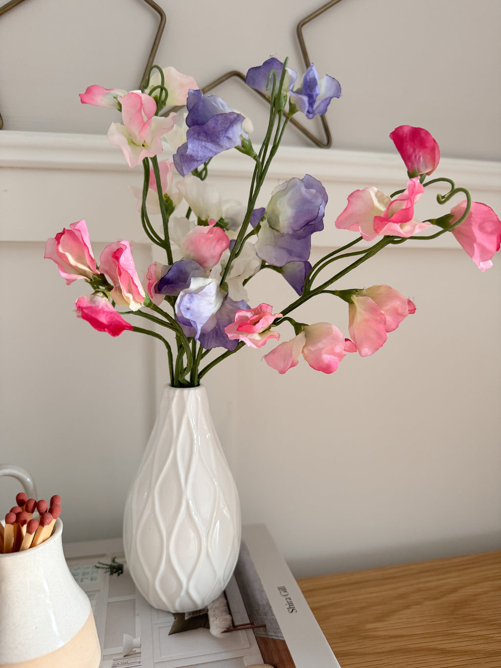 Sweet peas in white bud vase