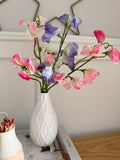 Sweet peas in white bud vase
