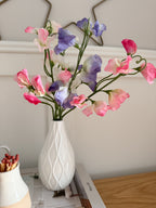 Sweet peas in white bud vase