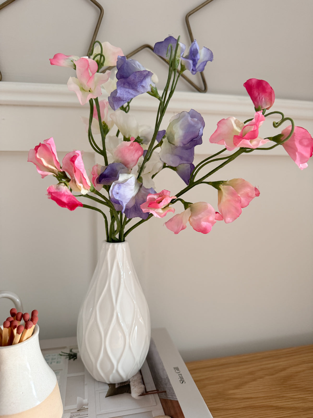 Sweet peas in white bud vase